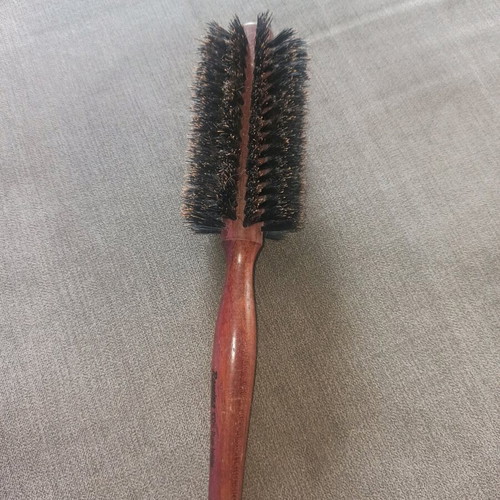 Round styling brush used, natural bristles