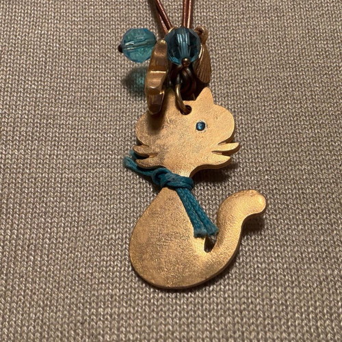 Cat design necklace like new, double brown leather cord with blue beads
