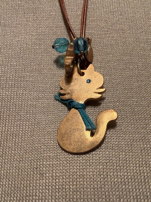 Cat design necklace like new, double brown leather cord with blue beads