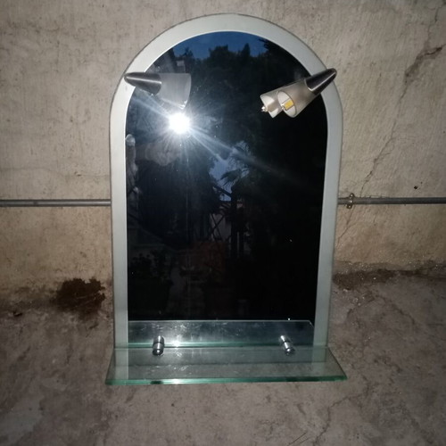 Semi-circular bathroom mirror used with 2 lights and shelf
