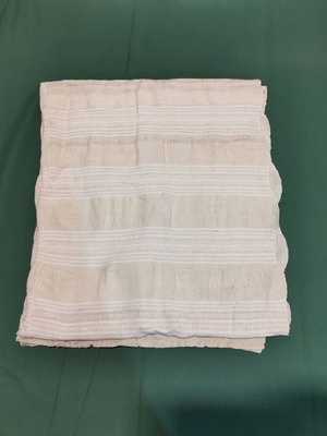 Woven throw used with stain and wear from 1930 era
