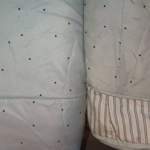 Single quilt used, thin with modern pattern