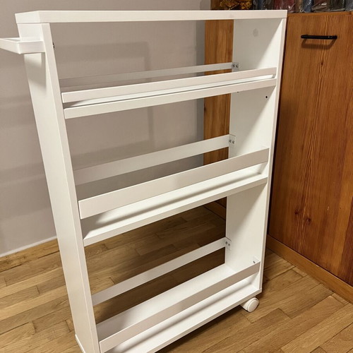 White kitchen shelf unit with adjustable shelf and wheels