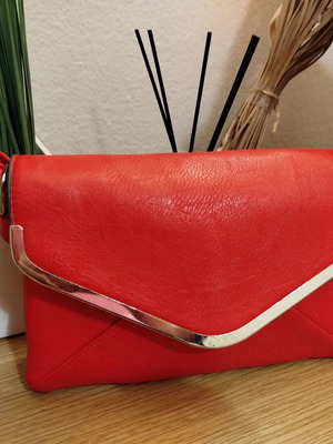 Red crossbody bag used with metallic detail