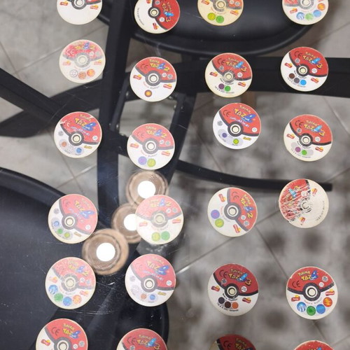 Pokemon Tazos used with visible wear