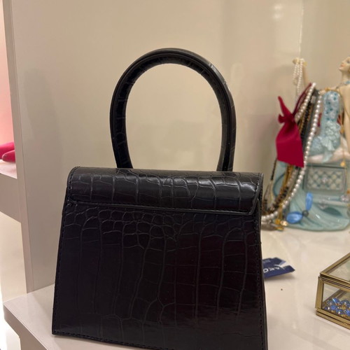 Small black handbag used with strap inside