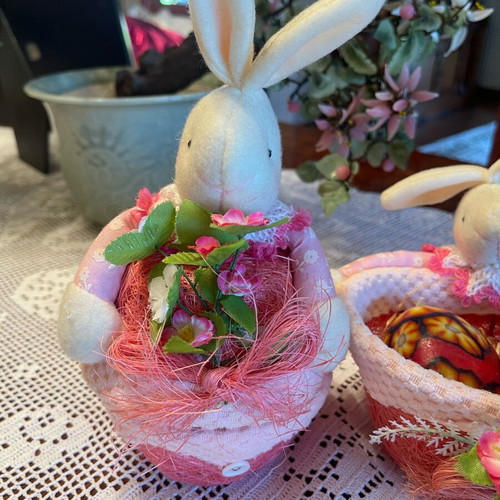 Easter decorations used, pink wicker baskets with rabbit and candle eggs