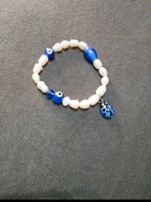 Handmade bracelet with evil eye and ladybug for all hand types