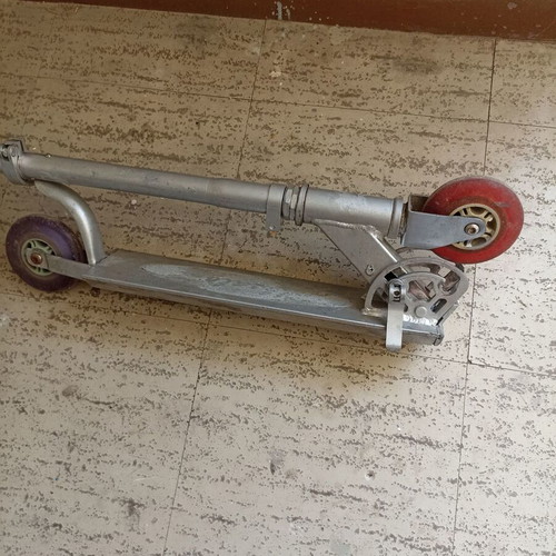 Silver metal scooter used, lightweight and foldable