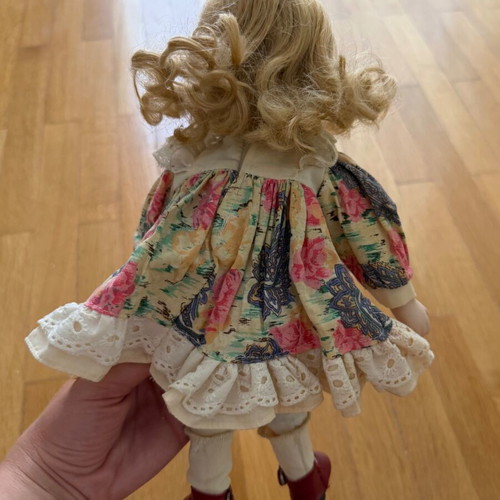 Porcelain doll like new with colorful dress and straw hat