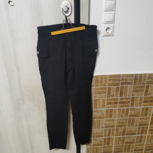 Black elastic women's pants with side pockets and buttons