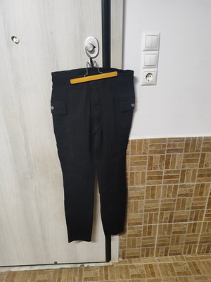 Black elastic women's pants with side pockets and buttons