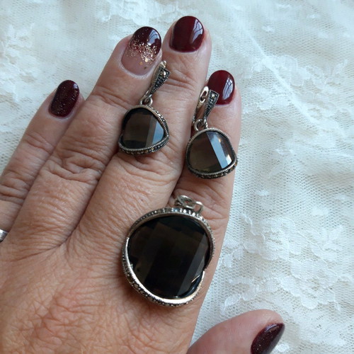 Silver set used with green transparent stones and marcasite