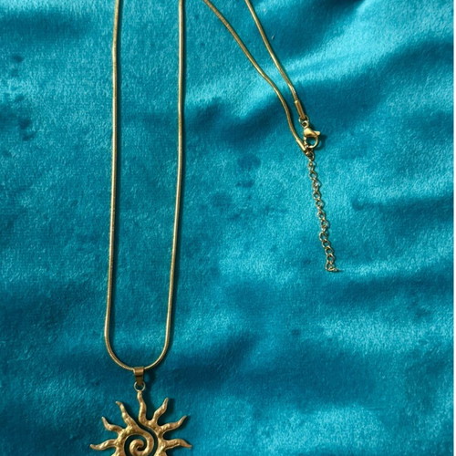 Gold necklace with sun pendant, new condition