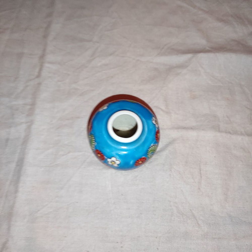 Small blue vase with porcelain flowers used