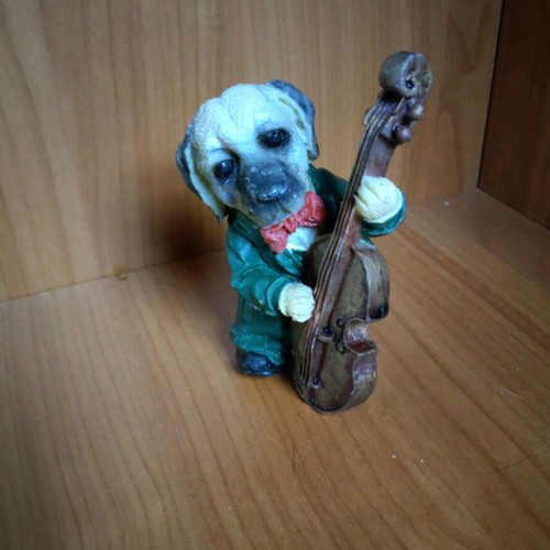 Decorative dog figure with cello like new