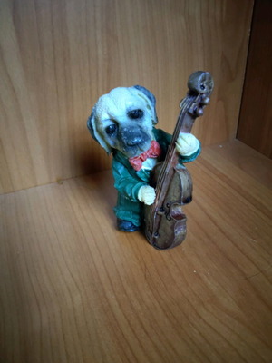 Decorative dog figure with cello like new
