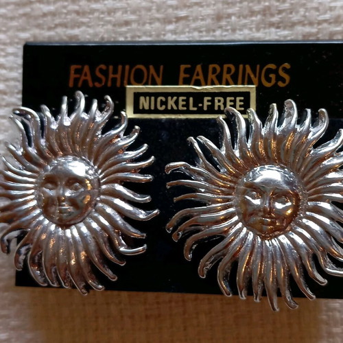 Clip-on earrings new, silver sun design