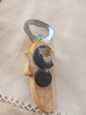Banana-shaped bottle opener magnet