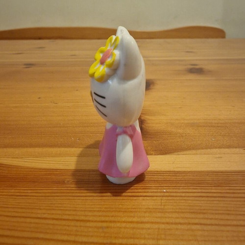 Hello Kitty figure used with pink dress and yellow flower