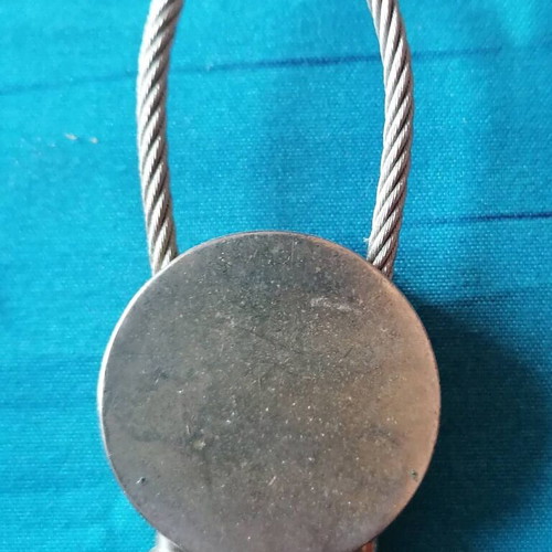 Keychain with moon and star design used, blue and silver