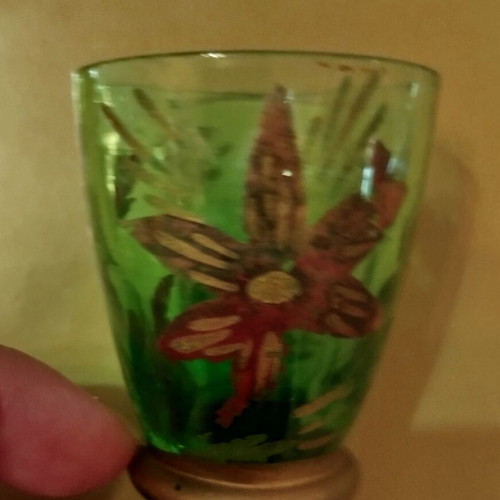 Vintage carafe with used red and green glasses