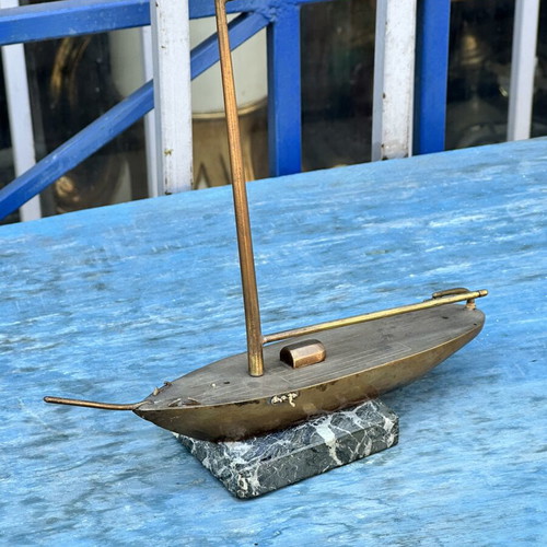 Vintage brass sailboat decoration on marble base, used