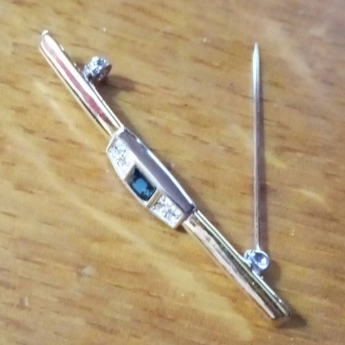 Jewelry pin like new, gold color with blue and clear stones