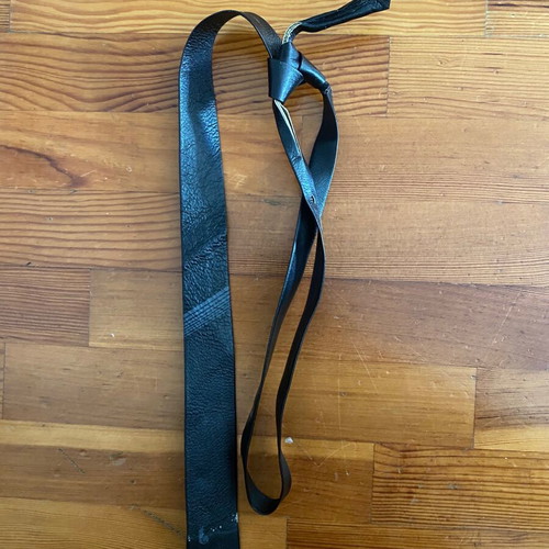 Leather thin black tie vintage used with fading marks