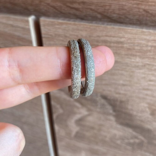Pair of silver earrings used with textured design