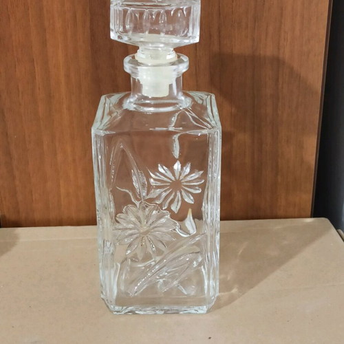 Glass bottle with embossed design like new