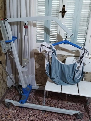 Mobiak Pegasus Patient Lift used with strap and stool chair