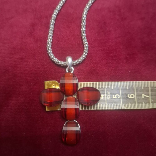 Cross pendant with silver chain, like new, deep red color