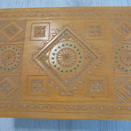 Old wooden carved box with decorative ornaments, used