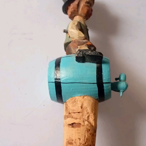 Cork used with carved wooden bottle stopper and boy figure