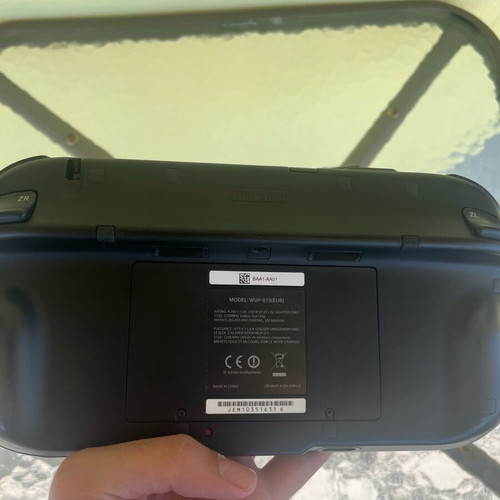 Nintendo Wii U console used with game cartridges and cables