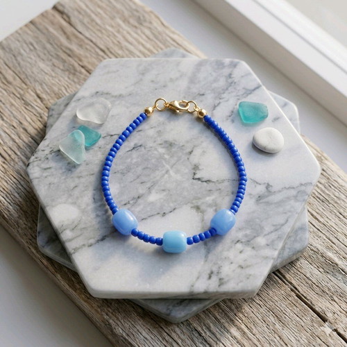 Handmade bracelet with blue beads and gold clasp like new