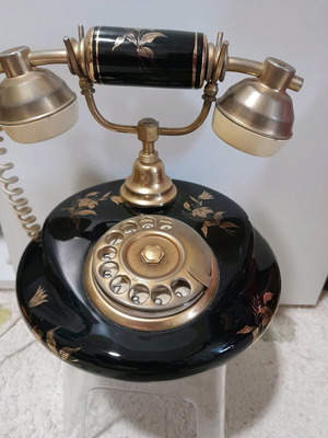 Antique telephone used, black with gold flowers