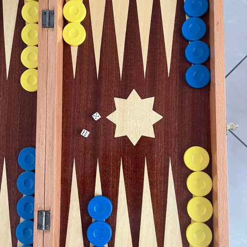 Wooden backgammon set used with colorful checkers and dice