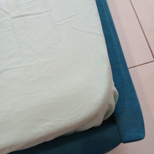 Single bed with teal fabric headboard and mattress, like new
