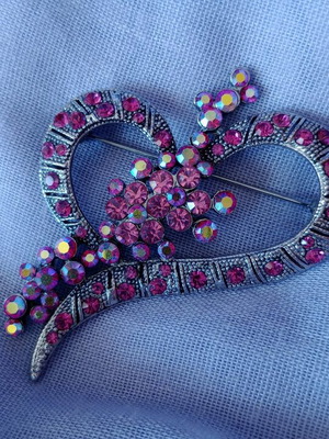 Pin with rhinestones used, heart-shaped in burgundy pink