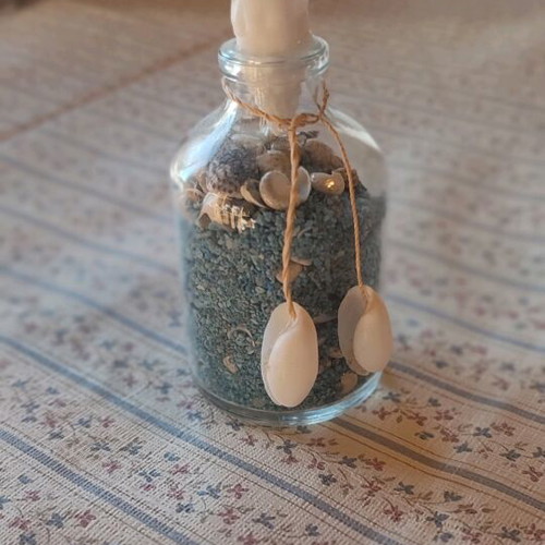 Glass bottle like new with shells and colorful sand