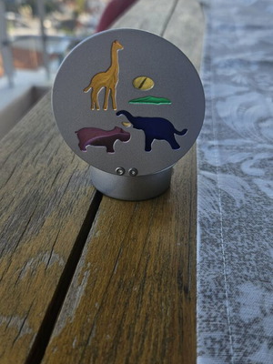 Metal tealight holder with stained glass animals