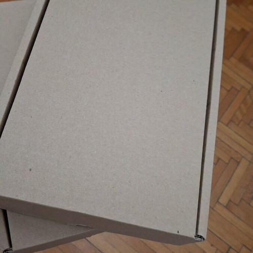 Four courier shipping boxes, kraft cardboard