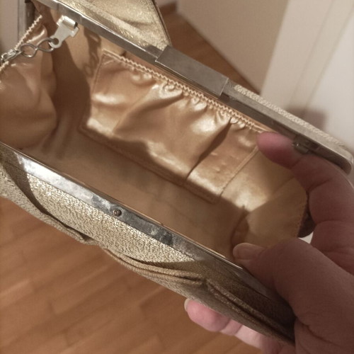 Gold evening bag with chain for crossbody use