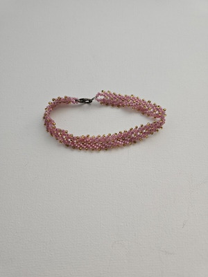 Handmade bracelet with pink beads and gold details used