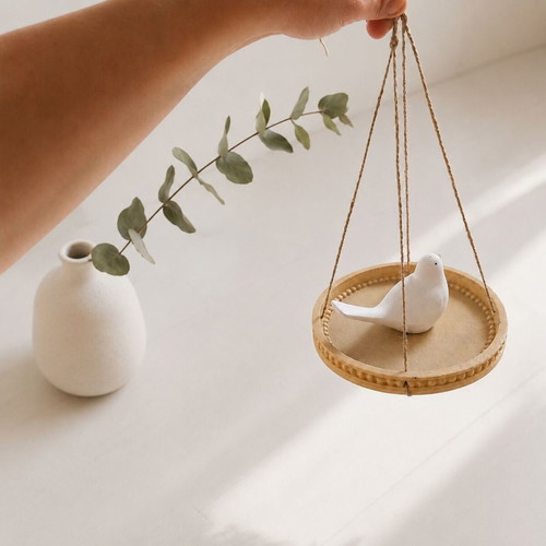 Decorative hanging bird on round tray like new