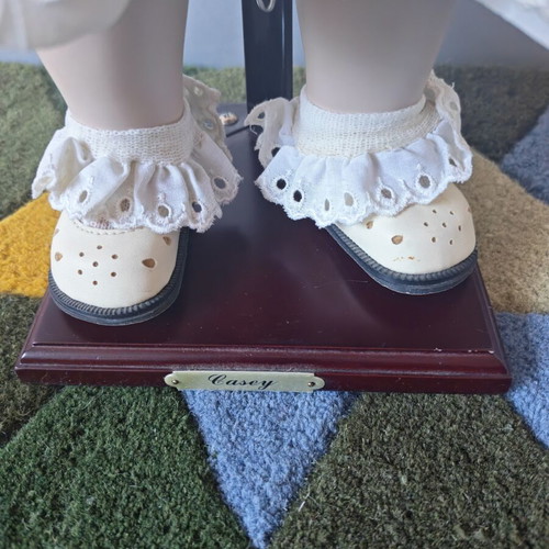 Alberon Casey porcelain doll with wooden stand, 50cm