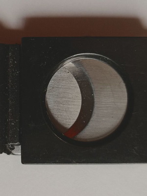 Black plastic cigar cutter used with metal cutting edges