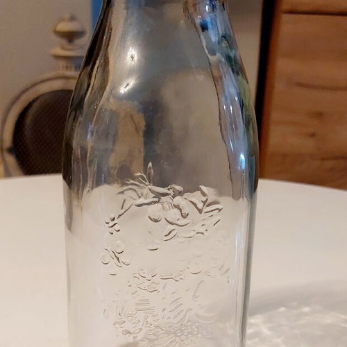 Glass bottle Frutta del Prato like new with embossed floral design